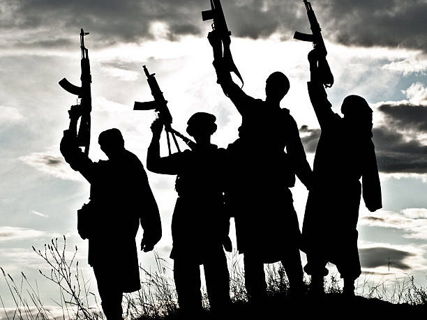 Silhouette of several muslim militants with rifles