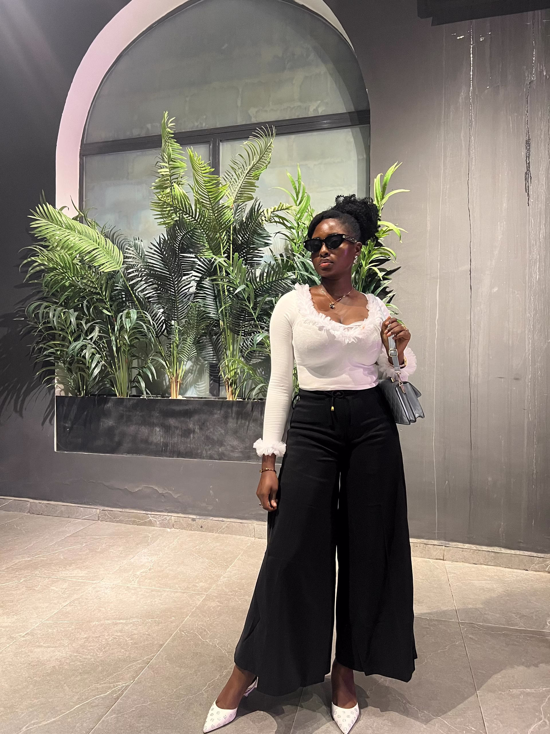 Eunice Akintayo Ayodeji painting in her studio at EuniceAkins Art, surrounded by vibrant oil colours and a fresh canvas.