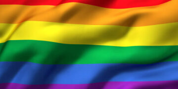 Rainbow flag blowing in the wind. Full page LGBT flying flag. 3D illustration.