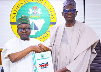 National Population Commission leaders shaking hands during official handover of population data, showcasing government collaboration on demographic information and statistics in Nigeria.