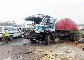Damaged truck collision with a minibus on the road after an accident, emergency response scene, commercial vehicle crash, traffic accident scene, accident investigation for roadway safety.