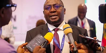 Expert businessman giving interview at a conference, surrounded by journalists with microphones, showcasing leadership and communication skills in the professional event.