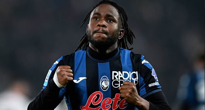 Brighton & Hove Albion football player celebrating during a match, wearing team kit with sponsor logos, on the field with a blurred stadium background.
