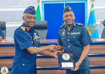 Honourable military officers shaking hands during an award ceremony at Freelanews, highlighting leadership, recognition, and military achievements in a professional setting.