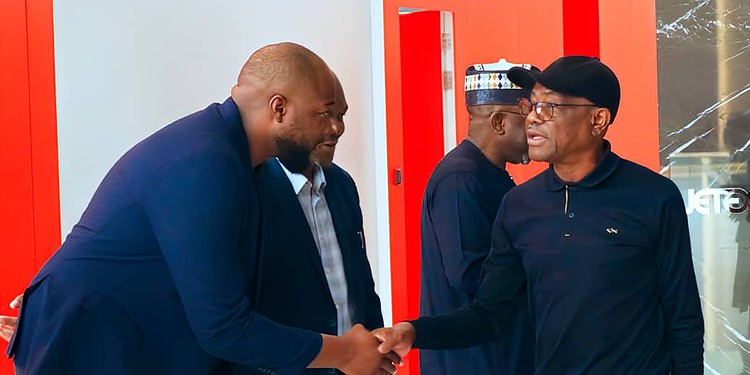 African business professionals shaking hands in a modern office setting, showcasing networking and collaboration.