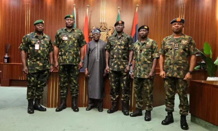 Nigeria military officers meeting government officials for national security briefing in an official government setting.