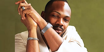 African American man in stylish business attire smiling confidently, showcasing diversity and professionalism for freelance work and remote employment opportunities.