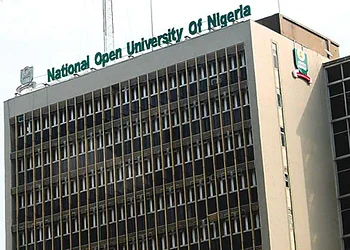 Modern university building with signage for the National Open University of Nigeria in Abuja, featuring architectural details and campus environment.