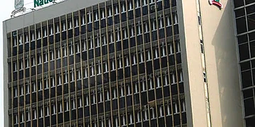 Modern university building with signage for the National Open University of Nigeria in Abuja, featuring architectural details and campus environment.