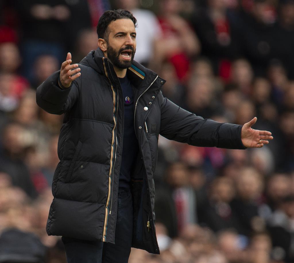 Energetic football coach passionately giving instructions on the sideline during a match.