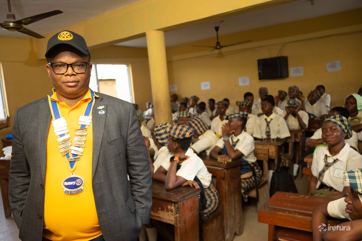 Brotherhood in education: A Rotary Club president visits a classroom with attentive students in their school uniforms, highlighting community engagement and youth empowerment.