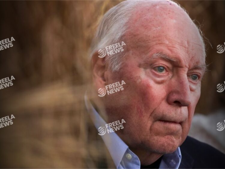 Close-up of an elderly man with white hair and blue eyes, expressing a serious or contemplative mood, featured on Freelanews, a platform for news and updates.