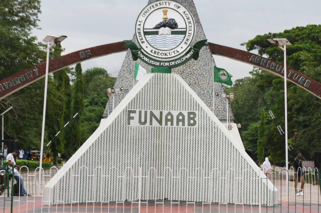 FUNAAB university entrance sign with logo, surrounded by greenery, representing Agricultural University Nigeria, a centre for research, development, and education in agriculture and related sciences.