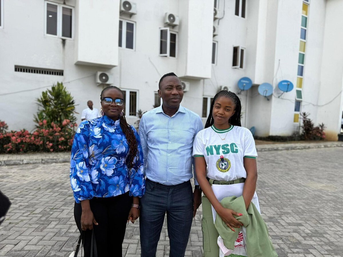 Image of young women and a man standing outdoors on campus, dressed in casual and academic attire, symbolising education achievement and youth empowerment.