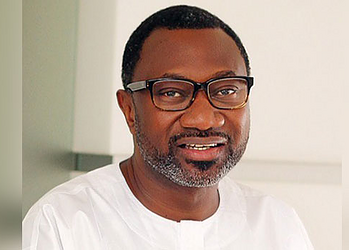 Clergyman wearing glasses smiling indoors, portrait representing leadership and community support for Freelanews audience.