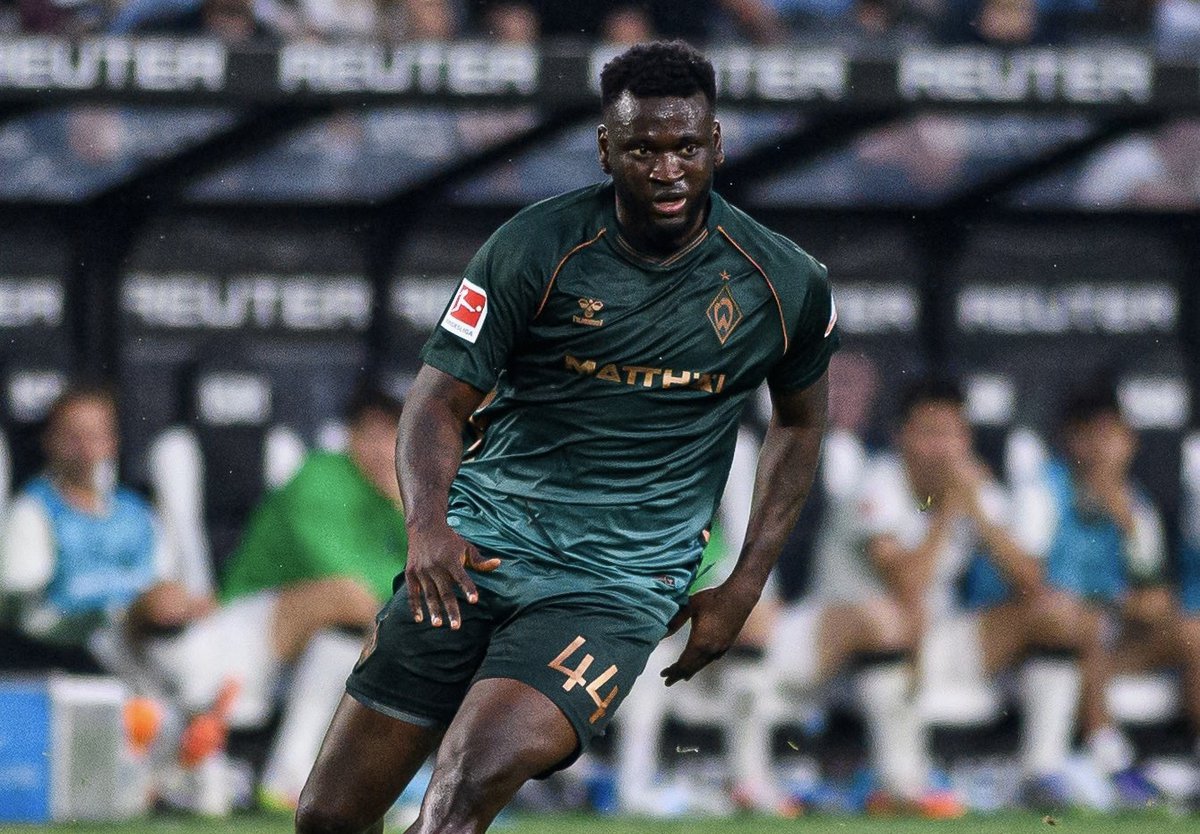 A passionate football player in action, showcasing skill and determination during an intense game.