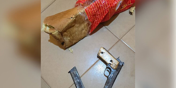 Unsecured firearm and ammunition on tiled floor alongside a torn bread bag, highlighting safety hazards and the importance of gun security in homes.