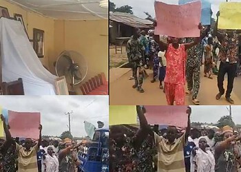 Empty conference room with draped white cloth and standing fan, symbolising event preparations.