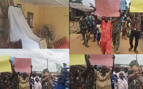 Empty conference room with draped white cloth and standing fan, symbolising event preparations.