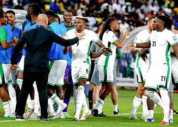 Energetic football team celebrating victory on the field, coach giving instructions, players in jerseys with green and white, colourful stadium crowd in the background, showing team camaraderie and sportsmanship.