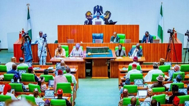 Members of a government or legislative assembly meeting in a formal chamber in Nigeria, highlighting governance, parliamentary proceedings, and political decision-making.