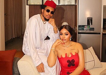 Stylish young man and woman dressed elegantly in a modern interior setting, showcasing fashion and lifestyle content.