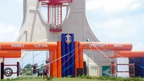1. Large rally tower with vibrant orange inflatable structures and university branding for sustainable event setup and outdoor education activities.