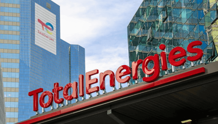 Electricity and energy provider TotalEnergies headquarters in an urban cityscape with modern glass buildings, showcasing renewable energy commitment and innovative energy solutions.