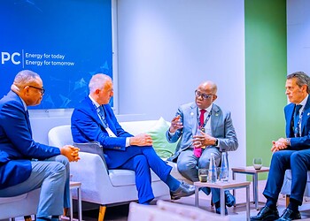 Innovative energy leaders engaging in a strategic discussion at a professional conference, emphasising renewable energy and global sustainability initiatives.