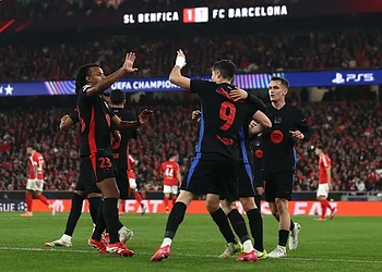 Celebrating FC Barcelona players during a UEFA Champions League match at Estádio José Alvalade, Lisbon. The team shows unity and excitement after scoring against SL Benfica.