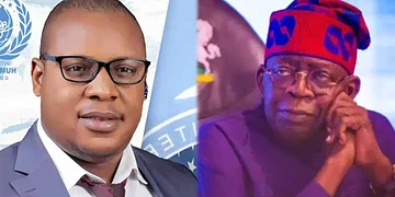 Official portrait of a young man in a suit and glasses with the United Nations logo in the background, representing diplomacy or international relations.