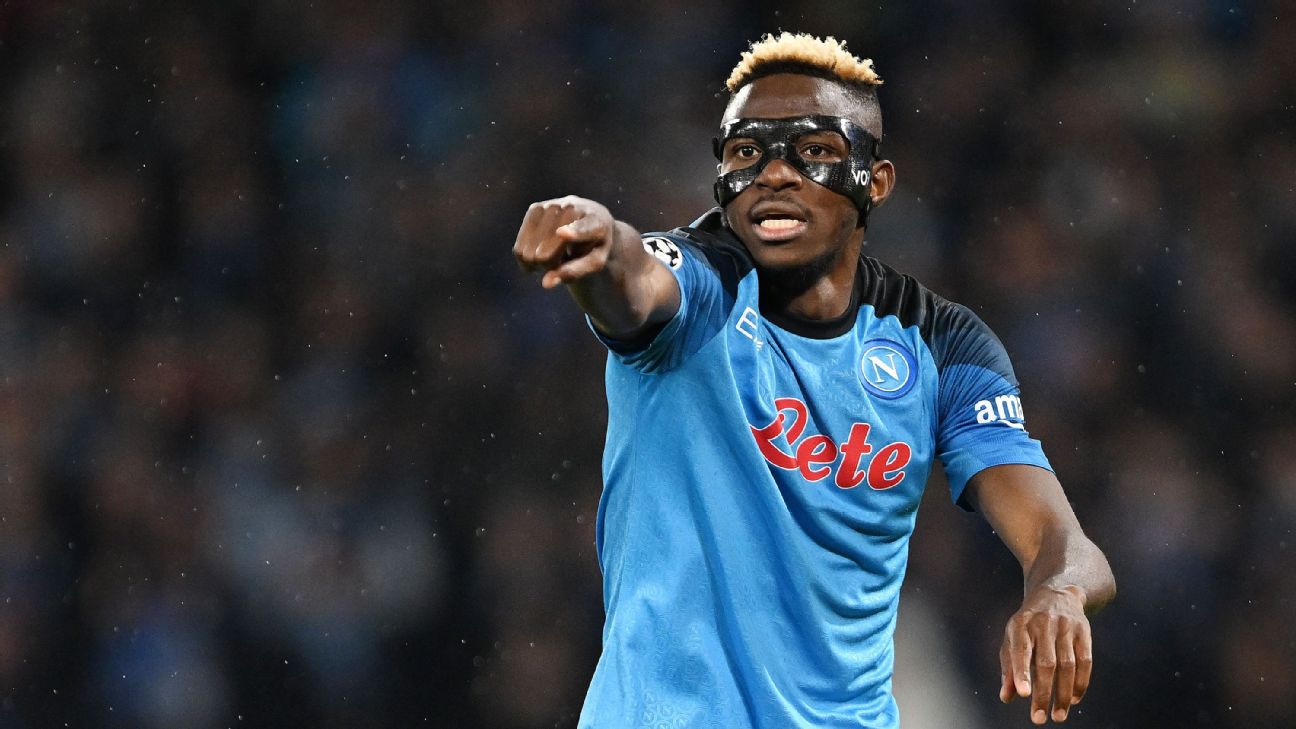Dynamic football player celebrating on the pitch, wearing Napoli kit and eye mask, showcasing passion and energy, with a blurred stadium background.